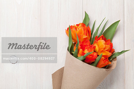 Colorful tulips over wooden table background with copy space