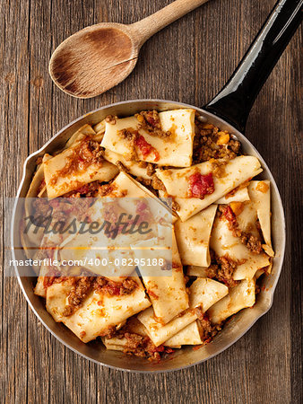 close up of rustic italian pasta in ragu sauce