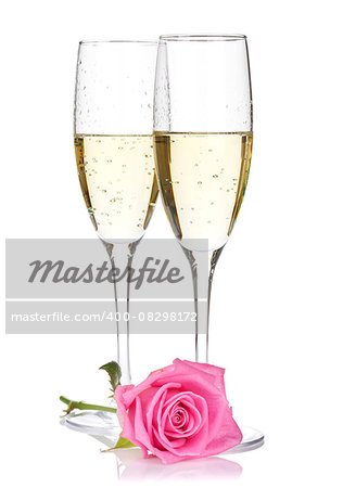 Two champagne glasses and pink rose flower. Isolated on white background