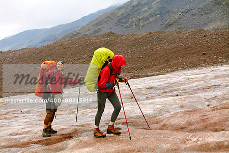 hikers on a glacier under the rain