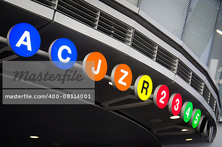 New York City Subway lines (A, C, J, Z, R, 2, 3, 4, 5) listed at the entrance to Fulton Center hub station in the Financial District.