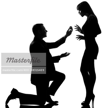 one  couple man kneeling offering engagement ring and woman surprised in studio silhouette isolated on white background