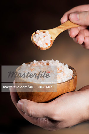 Himalayan salt, wooden spoon and bowl.