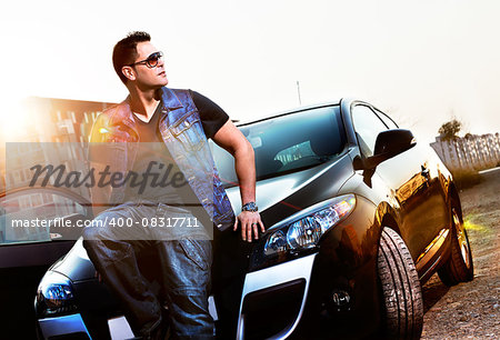 Portrait fashion man and car.Sunset cityscape