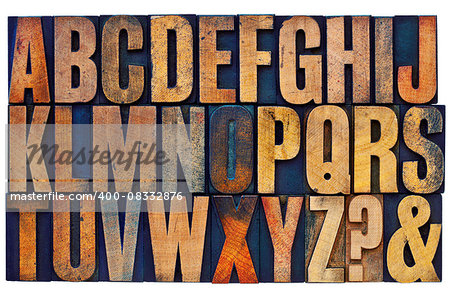 26 letters of English alphabet, question mark and ampersand - vintage letterpress wood type printing blocks stained by color inks