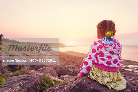 Adorable little girl looking at the sunset (Northumberland Strait near the Confederation Bridge mainland New Brunswick)