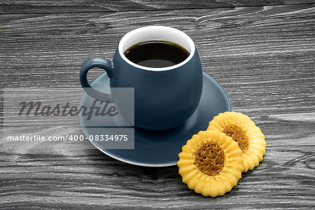 Grey ceramic cup of coffee on a wooden background.