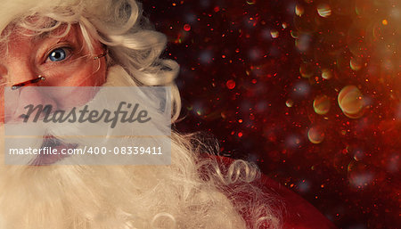 Closeup of Santa Claus with a magical holiday background