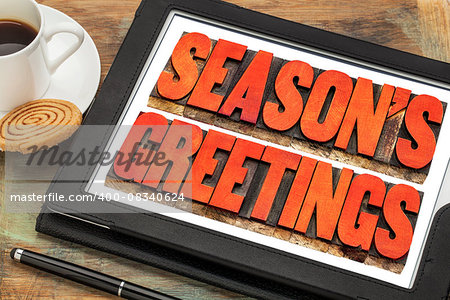 season greetings typography - text in letterpress wood type on a digital tablet