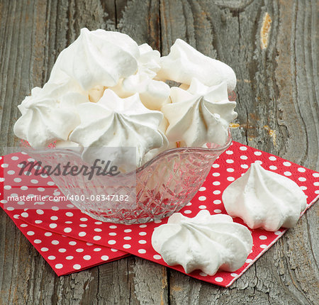 Dessert Vase with White Meringue Cookies on Red Polka Dot Napkin closeup on Rustic Wooden background