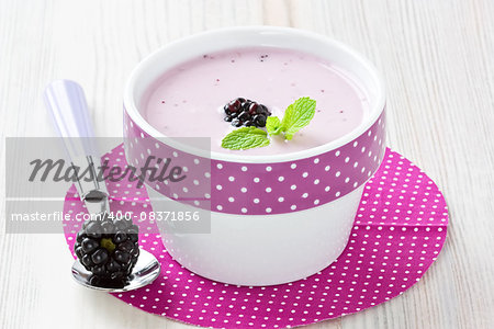 Fresh yogurt with sweet dewberry for healthy breakfast