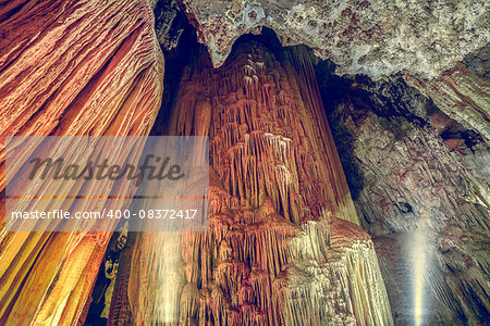 Cave colorful stalactites and stalagmites