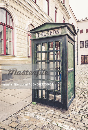 Old green retro street public call-box for telephone calls