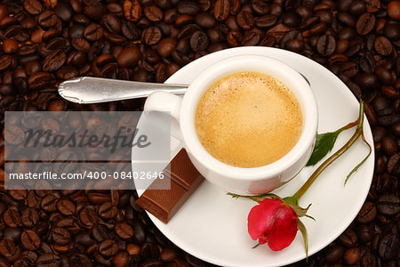 White cup of coffee with red rose
