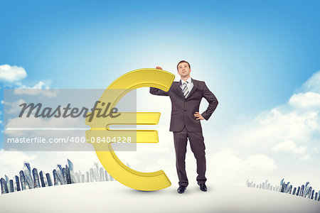 Businessman leaning on euro sign on cityscape background