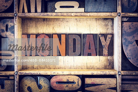 The word "Monday" written in vintage wooden letterpress type.