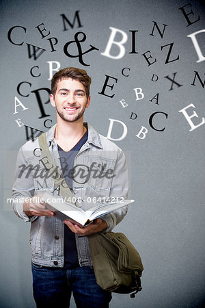 Student smiling at camera in library against grey background