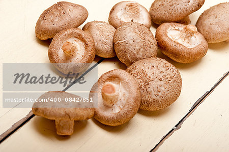 fresh shiitake mushrooms on a rustic wood table