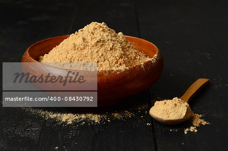 Maca root powder in a wooden bowl