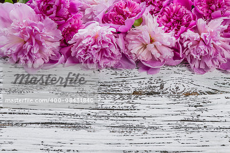 Peony flowers on wooden boards, rustic background