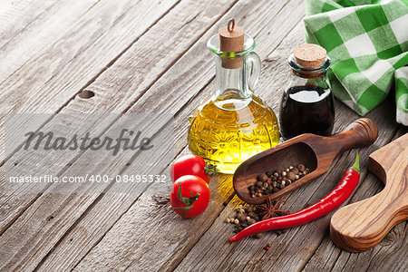 Spices and condiments on wooden table. View with copyspace