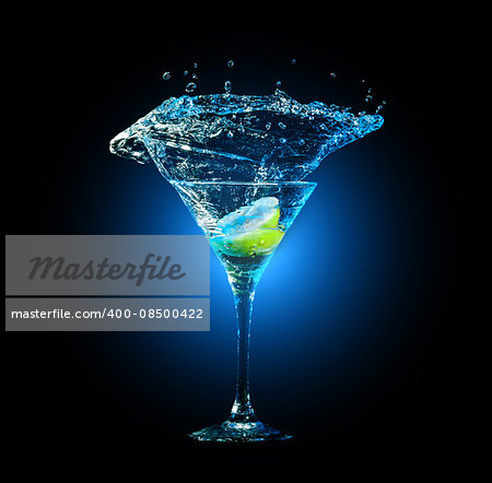 cocktail in glass with splashes and lemon on dark background. Party club entertainment. Mixed light