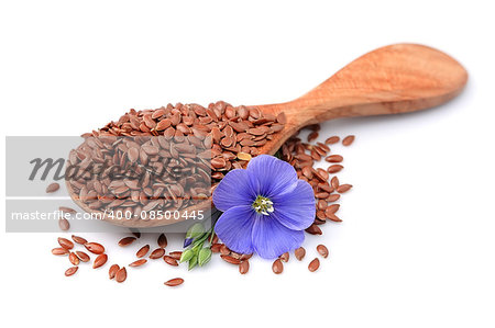 Flax seeds with flowers close up on white.