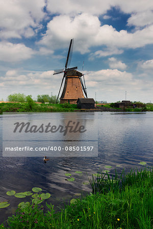 dutch windmills reflecting in river at summer day, Kinderdijk, Holland
