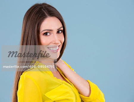 young woman wearing yellow shirt on blue background