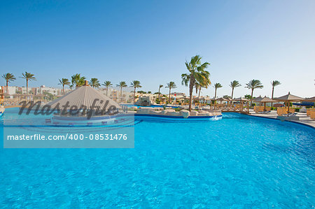 Large swimming pool with bar at a luxury tropical hotel resort