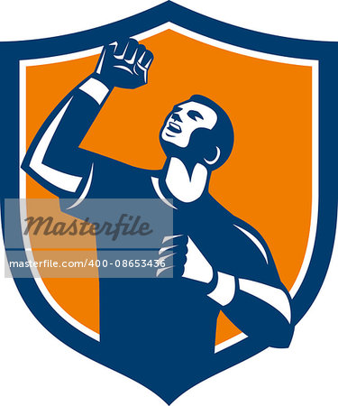 Illustration of a male athlete doing a fist pump looking up viewed from low angle set inside shield crest on isolated background done in retro style.