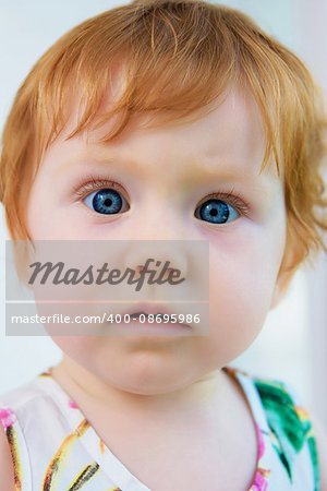 Girl-toddler looking to camera. Close-up.