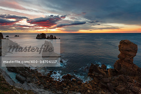 Sunset Atlantic ocean rocky coastline near Portio Beach (Pielagos, Cantabria, Spain).