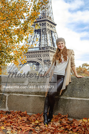 Autumn getaways in Paris. Full length portrait of happy young tourist woman on embankment near Eiffel tower in Paris, France