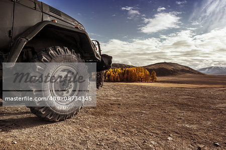 Truck car wheel on offroad steppe adventure trail