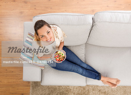 Top viw of a beautiful woman at home eating a healthy bowl