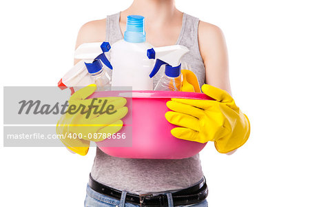 Unknown female holding pink basin with different cleaning substance. Studio photo on white background.