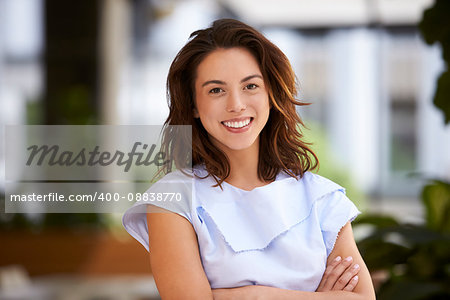 Close up of young mixed race businesswoman looking at camera