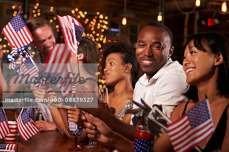Friends celebrating July 4th at a party in a bar