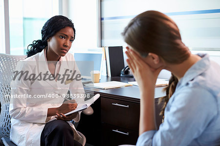 Doctor In Consultation With Depressed Female Patient