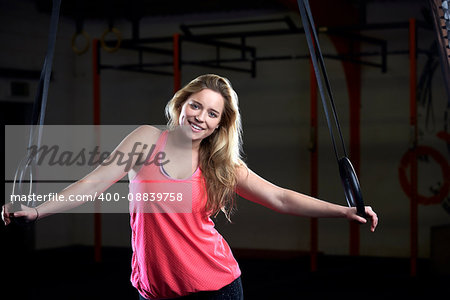 Portrait Of Young Woman In Gym With Olympic Rings