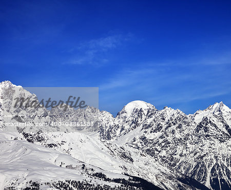 Snow mountains and blue sky in winter at sun day. Caucasus Mountains. Svaneti region of Georgia.