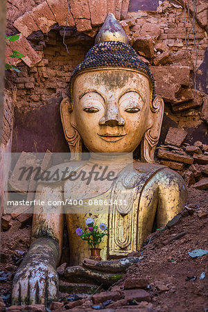 Buddha statue hiding in the ruins of the Shwe Inn Dein Pagoda at Inle Lake Shan state in Myanmar