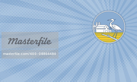 Business card showing Illustration of a great blue heron perched on a branch viewed from the side set inside circle with barn farm silo in the sunburst background done in retro style.
