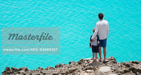 panorama of father and son enjoying beautiful anguilla island at caribbean