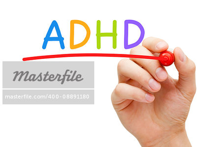 Hand writing ADHD Attention Deficit Hyperactivity Disorder with marker on transparent glass board.