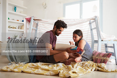 Father And Daughter Playing Indoors In Home Made Den