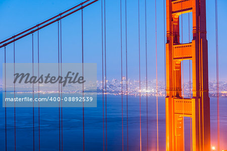Night view at illuminated Golden Gate Bridge which spans Golden Gate strait at San Francisco Bay. California, USA