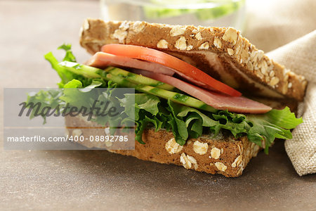 wholegrain sandwich with ham, tomato, cucumbers  and pickles
