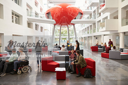 Students socialising in the modern lobby of their university